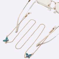 Gold-colored metal non-slip chain, with blue butterfly, for glasses and masks GL1498