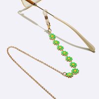 Gold-colored metal non-slip chain, with green daisy, for glasses and masks GL1647