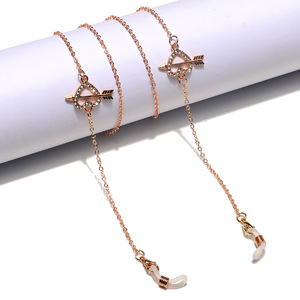 Golden glasses chain with rhinestone arrow through the heart GL1213