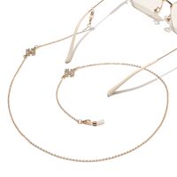 Gold-colored metal non-slip chain, with cross with rhinestone, for glasses and masks GL1445