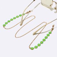 Gold-colored metal non-slip chain, with green daisy, for glasses and masks GL1647